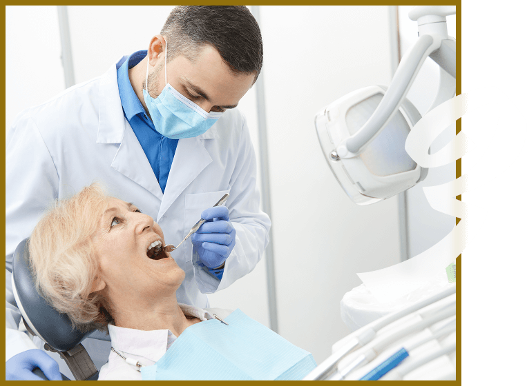 senior woman in dental chair while dentist examines her teeth