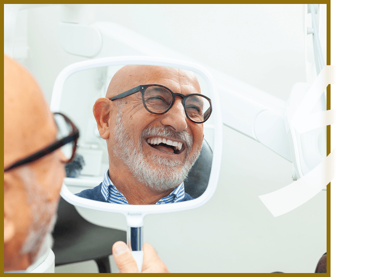 senior man smiling in mirror