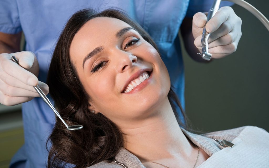 woman sitting in dental chair smiling