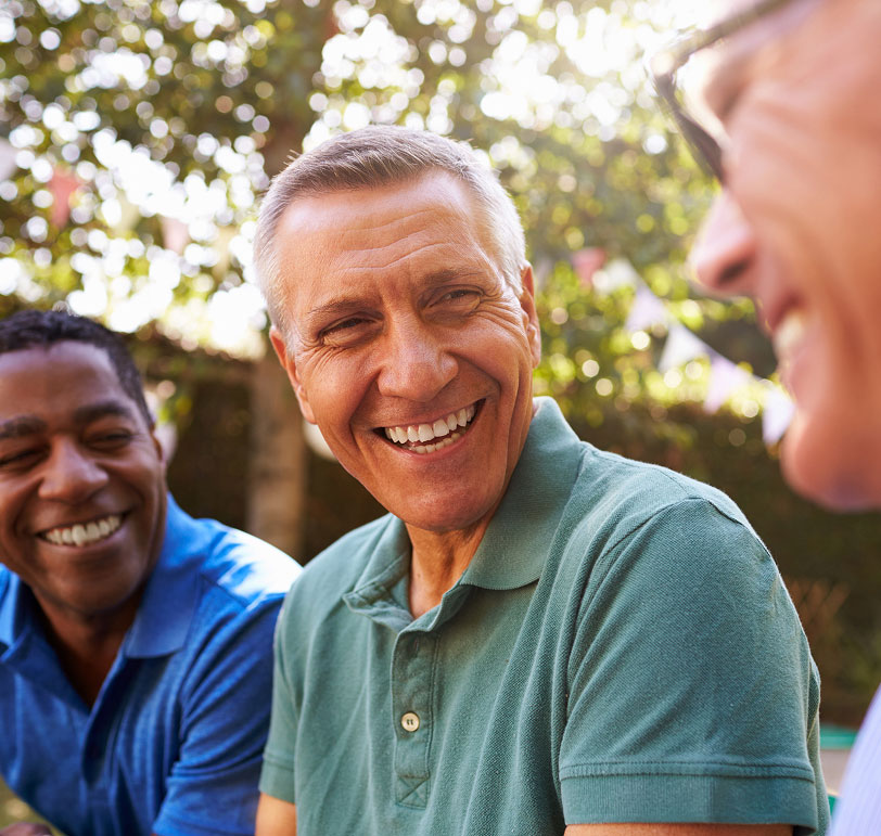 senior man smiling with friends